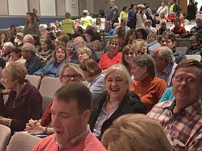 Audience members get comfortable in the Herndon Middle School auditorium for the Book Launch of  "A Minute to Midnight – an Atlee Pine Thriller" by David Baldacci.