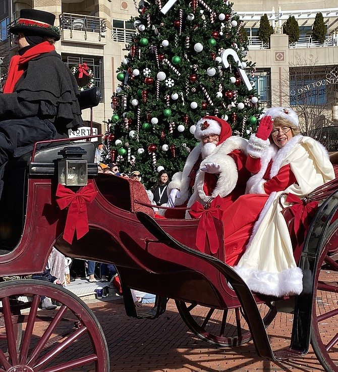 A jolly Santa Claus and Mrs. Claus arrive from the North Pole to Reston.