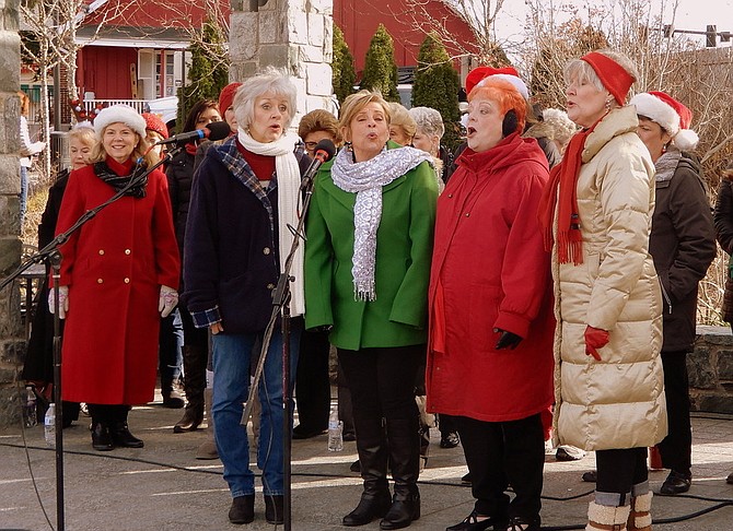 Members of the Vienna-Falls Chorus sing “We Wish You a Merry Christmas.”