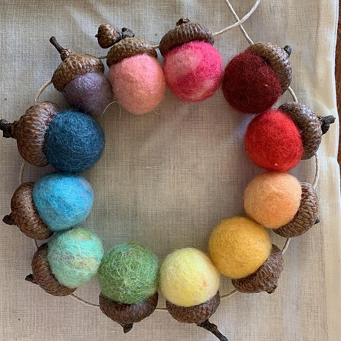 Artist Kathryn Coneway encourage students to create art using natural materials such as this wreath made of acorns and felt.