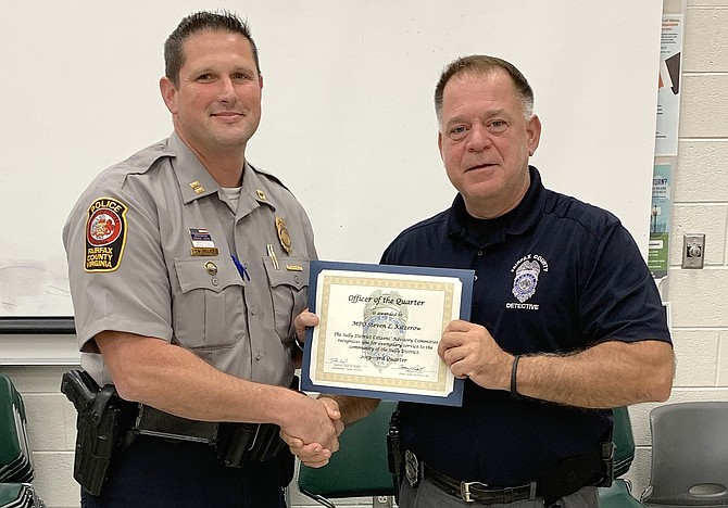 From left, Station Commander Capt. Todd Billeb presents the Officer of the Quarter award to Det. Steve Kitzerow.