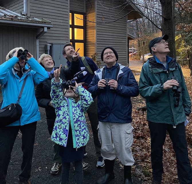 From left: Outside of Nature House in Reston, bird counters Joanne Bower of Reston; Barbara Ehst, Avery Ehst, 7, and Mike Ehst of Arlington; Jay Hadlock of Herndon; and David Bower look toward the treetops searching to sight the group's first feathered friend to tally in the 2020 Reston Association Winter Bird Count held Saturday, Jan. 4.