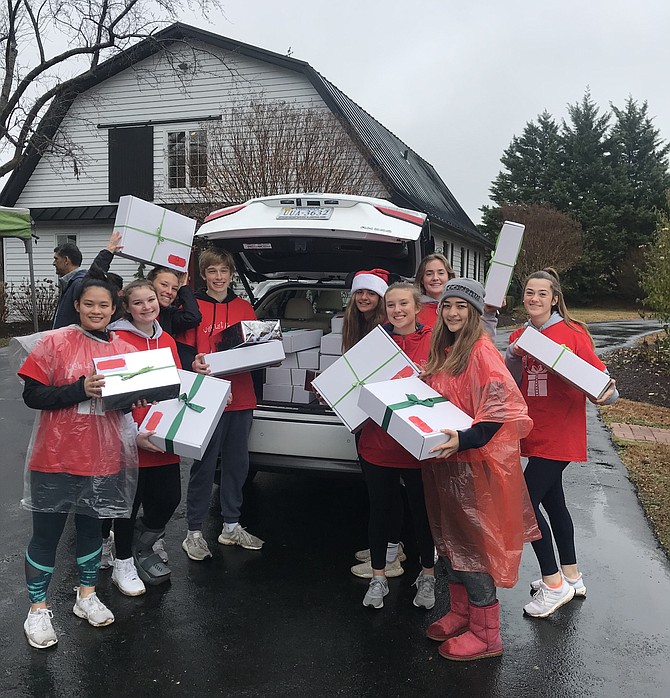 Local teens unload  more than 1,000 gifts from Wish List Angels at the Dec. 15 drive-through drop-off.