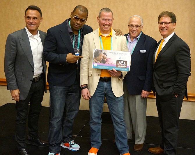 Ryan Herd, center, of CareGiver Smart Solutions, poses for a photo with judges after winning the ShowStoppers LaunchIt pitch event Jan. 6 in Las Vegas. Herd founded the company that provides “aging in place” caregiver monitoring.