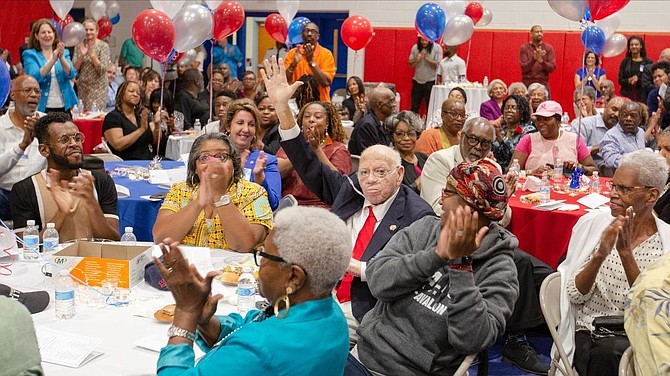 Former T.C. head football coach Herman Boone, center, acknowledges the crowd at the Oct. 3, 2019 T.C. Williams Athletic Hall of Fame Induction ceremony.