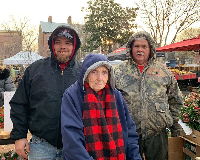 Doris Cassedy, center, poses with grandson Robbie Petit, right, and brother Lenny Dove on Dec. 21, 2019, her last day after selling flowers at the Old Town Farmers Market for 40 years.