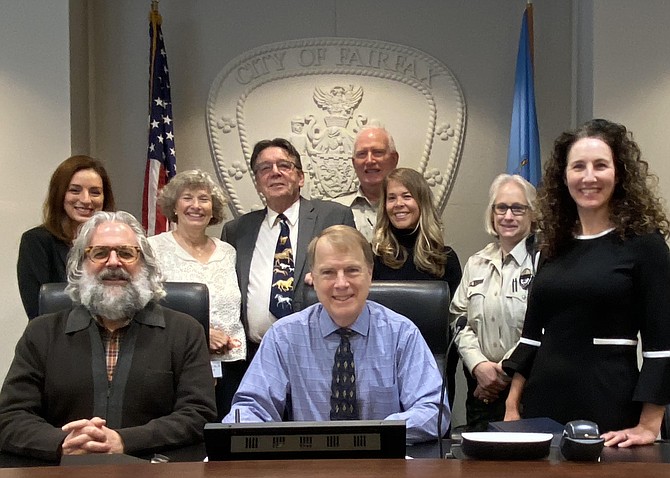 Animal advocates and animal control officers join Fairfax City Mayor and Councilman for the signing of the city ordinance requiring permits for pet stores. Seated: Michael DeMarco, Councilman; David Meyer, Mayor; standing: animal advocates, Giovanna DiBiccari, Susan Laume, Tim Parmly, Sue Bell and Lori Huberman-Hayes; Fairfax Animal Control Officer Terry Carroll.