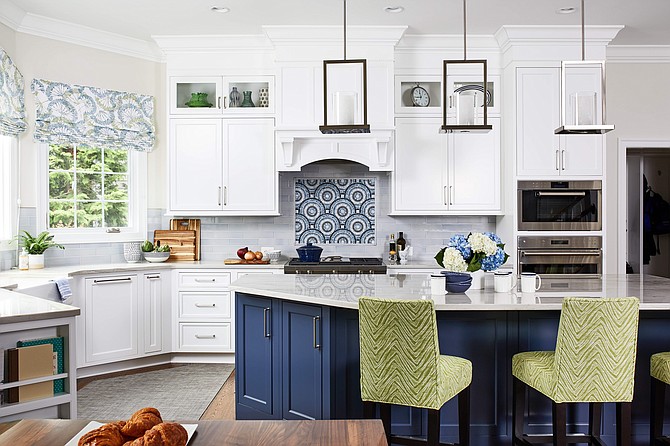 Designer Allie Mann Classic added blue island cabinetry, and accenting blue tiles as the backsplash above the range, in this Arlington, Virginia kitchen.