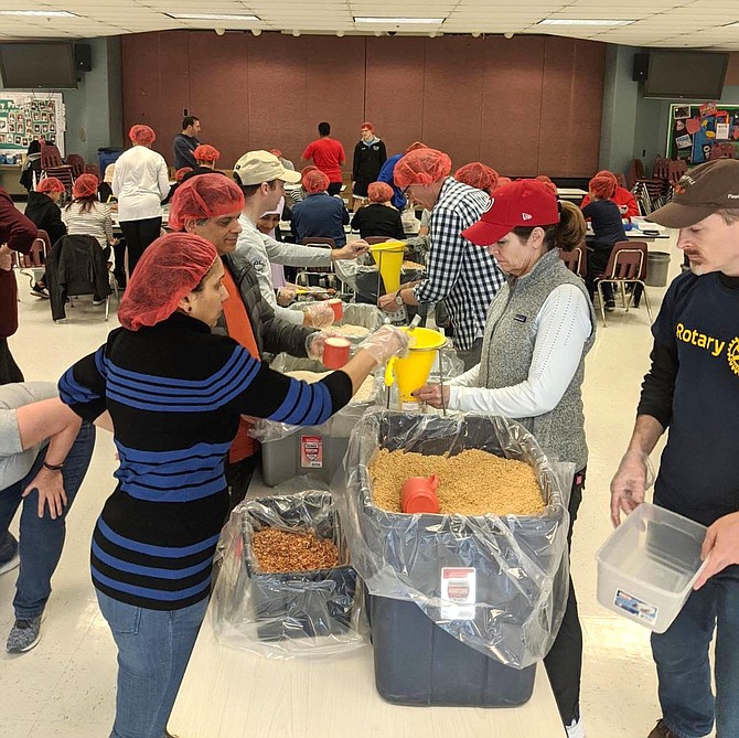 Many hands make quick work of filling, weighing, sealing and packing 10,152 counted meal bags during the Rotary Club of Reston's service project partnering with Rise Against Hunger.