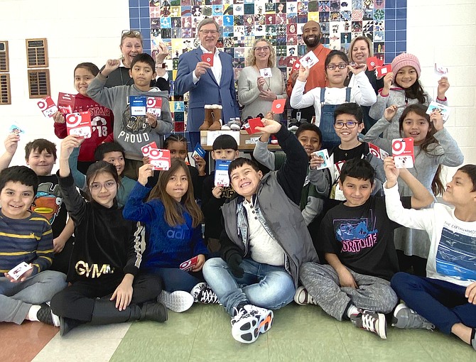 From left: Joanne Ormesher, Arts Herndon, Dranesville Supervisor John W.  Foust (D), Jenny Phipps of Foust’s office, and Assistant Principals at Hutchison Elementary School, Steven Wilson and Katie Aldridge, join with students in showing off community contributions donated to the Supervisor's Annual Shoe Drive to benefit children in need at the Title 1 school.