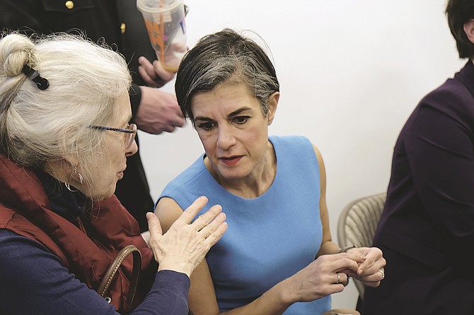 Parisa Dehghani-Tafti, Arlington Commonwealth’s Attorney, talked to a resident at the meeting.