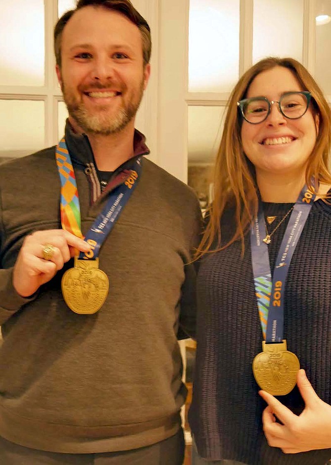 Desy and Babb display their NYC marathon medals.