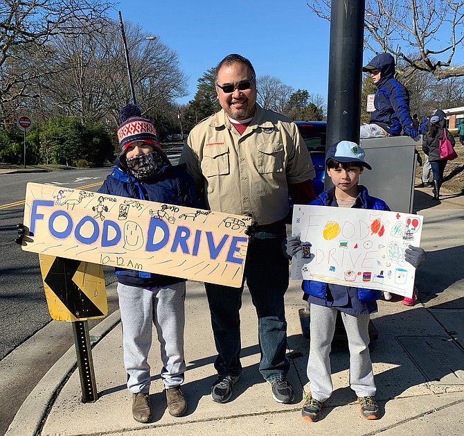 Cub Scout Pack 801 leader Stephen Ng, center, with pack members Edward Ng and Alex Morris at the Jan. 20 food drive for ALIVE! at Douglas MacArthur Elementary School.