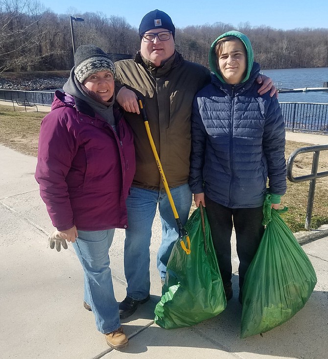 From left:  Brian, Tatiana and Thomas Lisle of Springfield participate in the Friends of Lake Accotink Park volunteer clean-up event on Monday, Jan. 20, 2020.