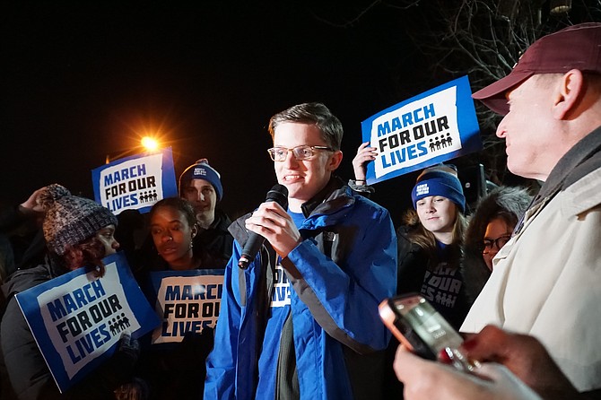 Robinson High School senior Michael McCabe, 17, tells fellow activists gathered Jan. 20 at a candlelight vigil in front of the National Rifle Association in Fairfax about the sense of urgency he and his peers feel about gun violence.