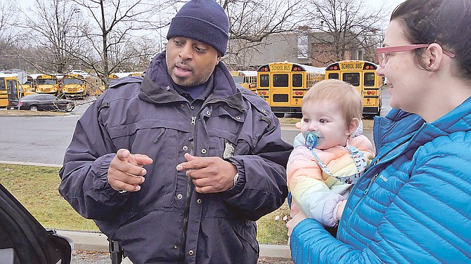 Officer Carl Stowe advises Jessica Diaz, who had come in with her daughter, 10-month-old Isabelle, to get an inspection of the infant seat.