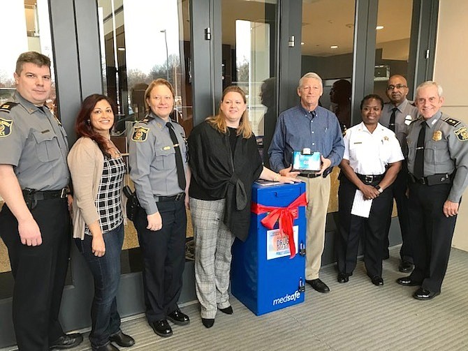 Officials participating in the Prescription Drug Take Back Day, left to right: Captain Gregg Ladislaw, Alexandria Police Department; Youth Development Team Leader Noraine Buttar, City of Alexandria Department of Community and Human Services; Captain Monica Lisle, Alexandria Police Department; Opioid Response Coordinator Emily Bentley, City of Alexandria Department of Community and Human Services; Allen Lomax, Chair of the Substance Abuse Prevention Coalition of Alexandria; Sergeant Valarie Wright, Alexandria Sheriff’s Office;  Captain Don Hayes, Alexandria Police Department Assistant Police Chief; Police Chief Michael Brown, Alexandria Police Department.