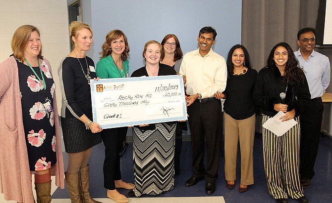 Rocky Run Principal Amy Goodloe (second from left) and her staff with a $60,000 check from Asha-Jyothi.