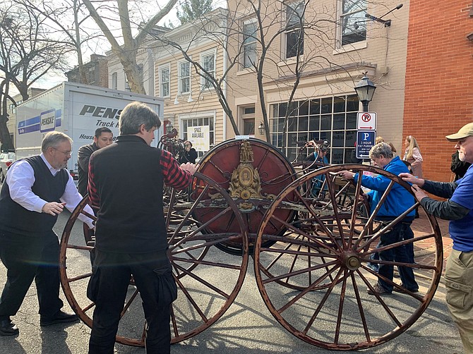 The 1858 Prettyman Hose Carriage is removed from the Friendship Firehouse Museum Feb. 1 in preparation for conservation work to restore the historic fire fighting apparatus.