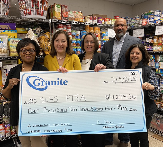 From left: Lucretia Mattar, Senior Financial Analyst and Lisa Martin, Administrative Assistant at the Greensboro Drive, Tysons Corner office of Granite Telecommunications, present a $4,500 donation check on behalf of the company to the South Lakes High School (SLHS) Parent Teacher Student Association (PTSA) Food Pantry on Feb. 2. Present to receive the donation is South Lakes High School Principal Kim Retzer, Paul D. Thomas, SLHS PTSA President and Roberta Gosling, SLHS Pantry Co-Founder.