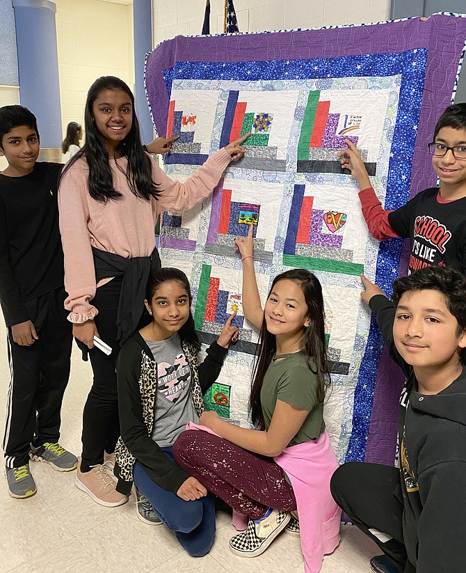 From left: sixth-grade students at McNair Elementary School in Herndon, Venkata Srikakolapu, 12, Anika Badatala, 12, Ria Goel, 12, Zoe Rodriquez, 12, Adarsh Iruvanti, 11, and Aditya Nair, 11, point out their favorite squares in a completed Love Quilt.