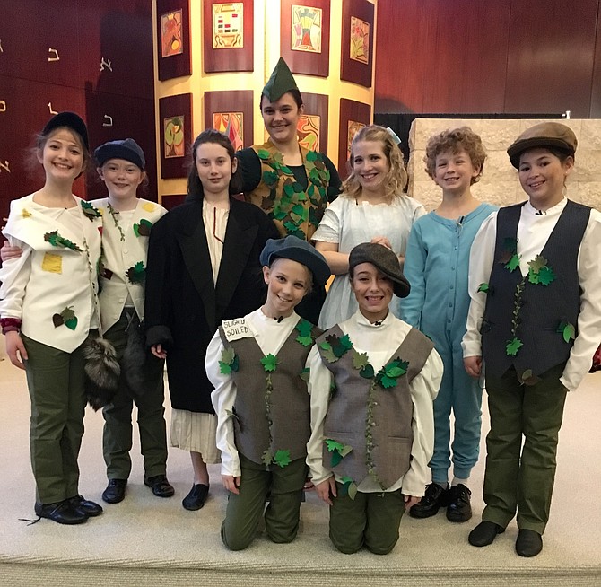 Peter Pan and Wendy pose with the Darling children and the Lost Boys  during dress rehearsal Sunday. Kneeling are Ella Fielding and Sydney Martin. Standing from left are Eden Shaw, Jackie Williams, Sari Gabel, Laura Searles, Jessie Dugan, Samuel Friel and Liat Topolosky.