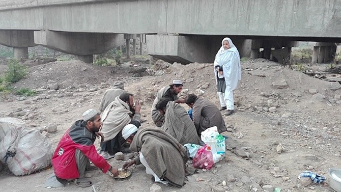 Maryam Bibi serves a morning meal to drug addicts this year in Pakistan.