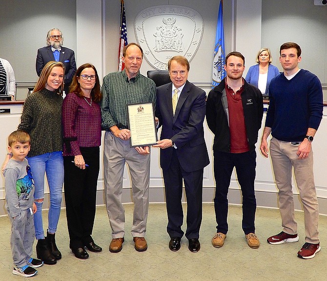 Honoree Scott Peirce (green shirt) with (from left) nephew CJ Ray, daughter Rachel Peirce, wife Mary McCullough, Mayor David Meyer, and sons David and Brian Peirce. (In back are Council members Michael DeMarco and Janice Miller).