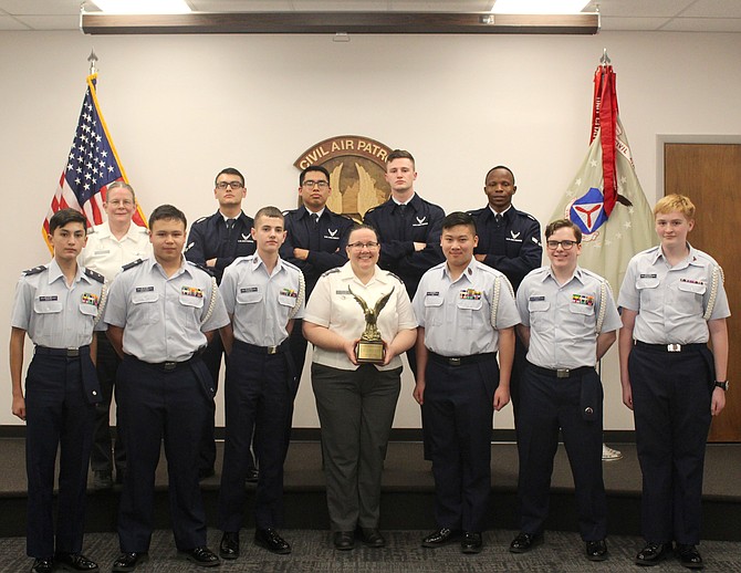The Burke Cadet Team with the winning trophy and the Joint Base Langley-Eustis Honor Guard judges in the back row.