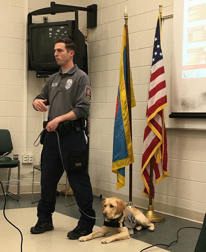 PFC Dusty Granofsky addresses the meeting while his dog, Lennie, listens.