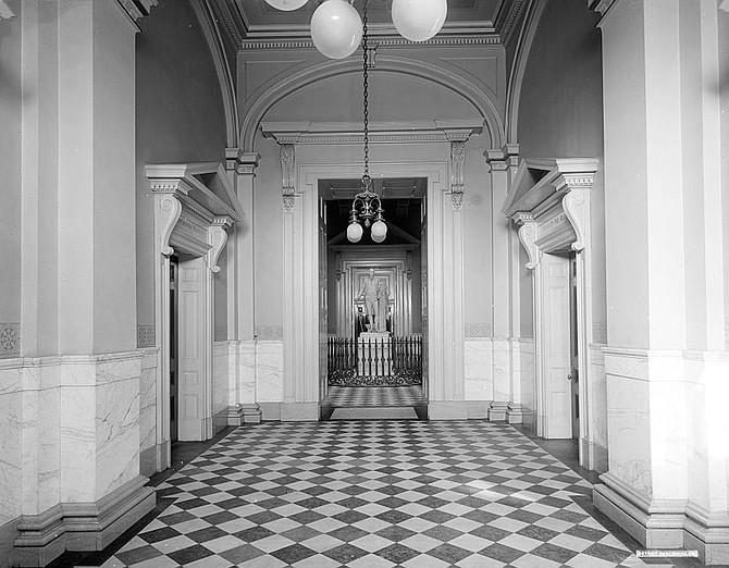 A statue of George Washington stands at the center of the hallway between the House of Delegates and the Virginia Senate, two chambers that have been at odds with each other this year.