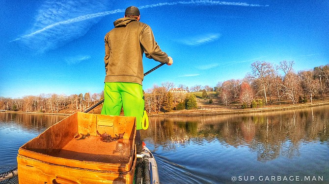 Just offshore from the Mount Vernon Plantation, the SUP Garbageman scours the shore.