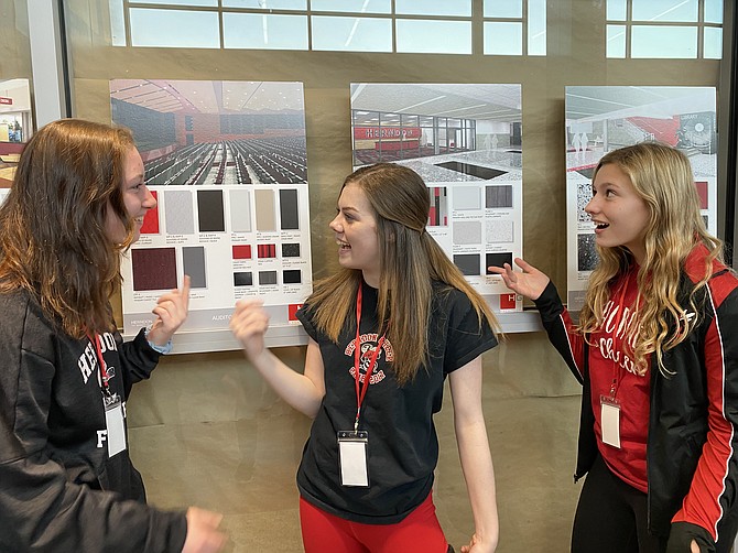 From left, Herndon Hornets: Cailley Graham, 15, of Herndon, Hannah Clements, 16, of Reston and Kate LaRosa, 16, of Reston take note of three renderings depicting plans of different renovations/additions for their school.