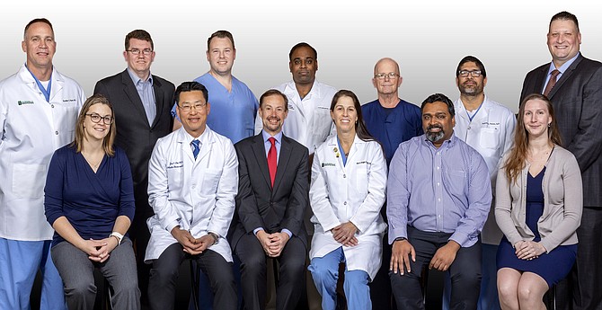 The Reston Hospital Center Trauma II team (front row, from left): Frances Hughes RN; Dr. Jae Lim; Dr. Peter Dougherty; Dr. Mary Boggs; Dr. Ranjit Pullarkat; Jessica Fuerstinger; (back row, from left): Dr. Brad Ryan; Dr. Brett Sachse; Lyle Ritch, PA; Dr. Anil Maliyekkel; Luther Surface, RN; Ruben Perez, NP; Dallas Taylor, RN.