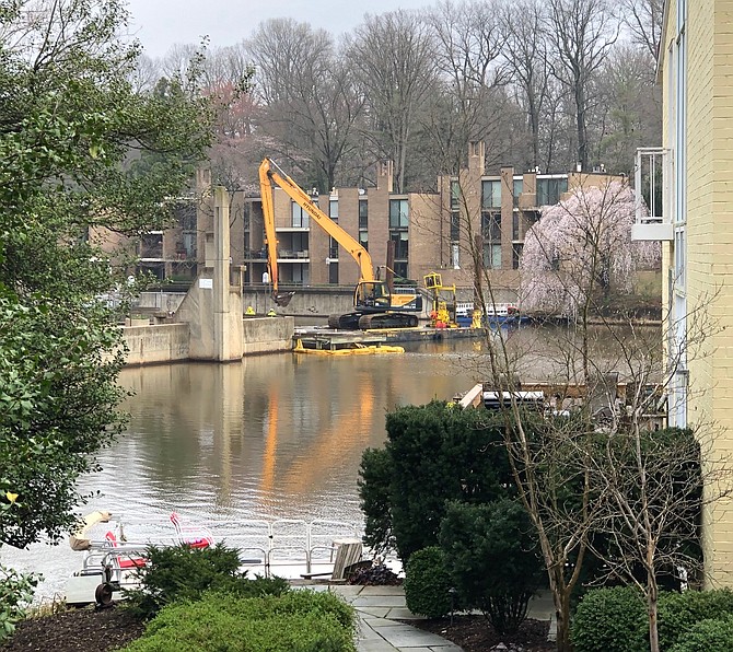 View of excavator in action from Washington Plaza Cluster across the water from dock work.