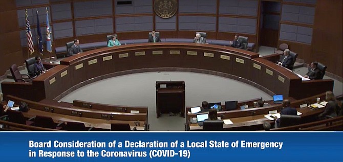 Sitting six feet apart, Fairfax County Board of Supervisors considers and unanimously approves a resolution of a Declaration of Local Emergency Management effective immediately, March 17, 2020, in response to the coronavirus (COVID-19).
