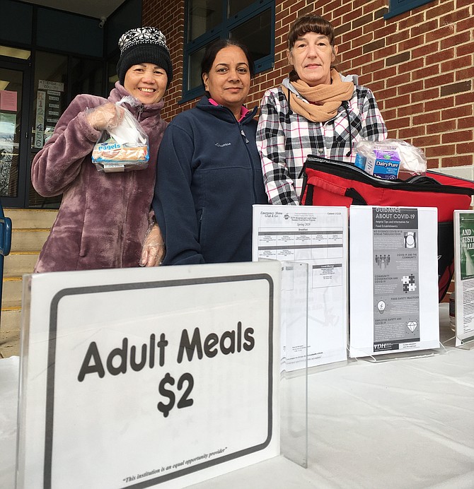 At Crestwood Elementary School in Springfield, Wednesday, March 18: Ketsana Phonemany, Ginger Swiger and Juz Kaur handed out free breakfast to area students.