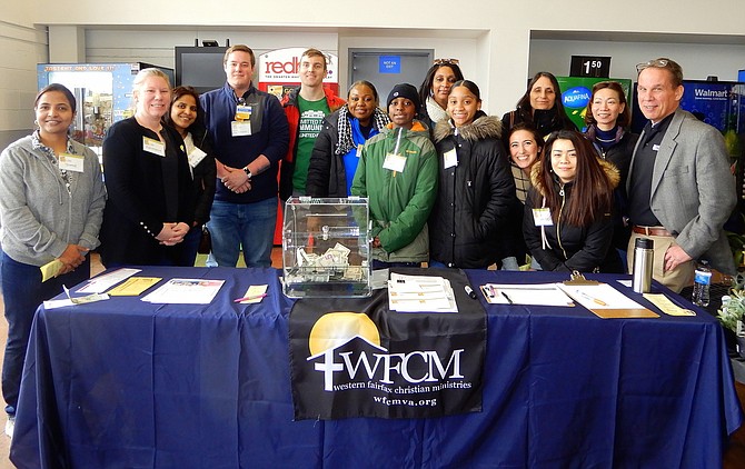 WFCM Executive Director Harmonie Taddeo (second from left) with county, community and business volunteers during the Feb. 29 Stuff the Bus event.