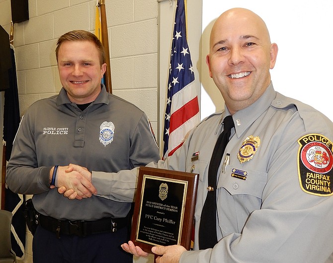 Lt. Josh Laitinen (on right) presents the 2019 Officer of the Year award to PFC Kory Pfeiffer.