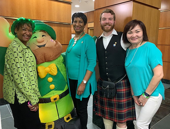 Dr. Elisabeth Palmer-Johnson, Marian Pegram and Paul Kentes get in the Irish spirit at the second annual Sips For Saints fundraiser sponsored by the Alexandria Central Rotary Club March 13 at The Atrium.