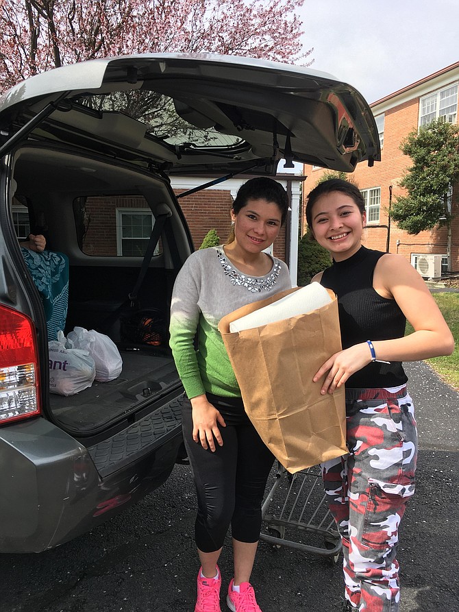 Wendy Rebera and Jenna Amendez load the car at Koinonia in Franconia.