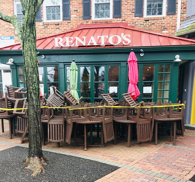 SIGNS OF THE TIMES: Tables and chairs are pushed back and roped off in front of Renato Restaurant to discourage people from gathering together outside.