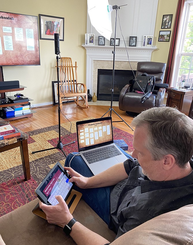 Senior Pastor Robert Wallace prepares for a streamed Wednesday night Bible study from his house for the Mclean Baptist Church congregation.