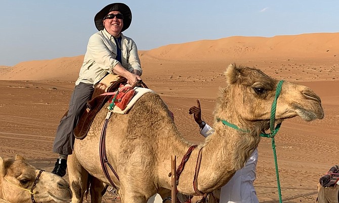 Brian Miller atop a camel during one of his many travel adventures. He visited 45 states and 65 countries.