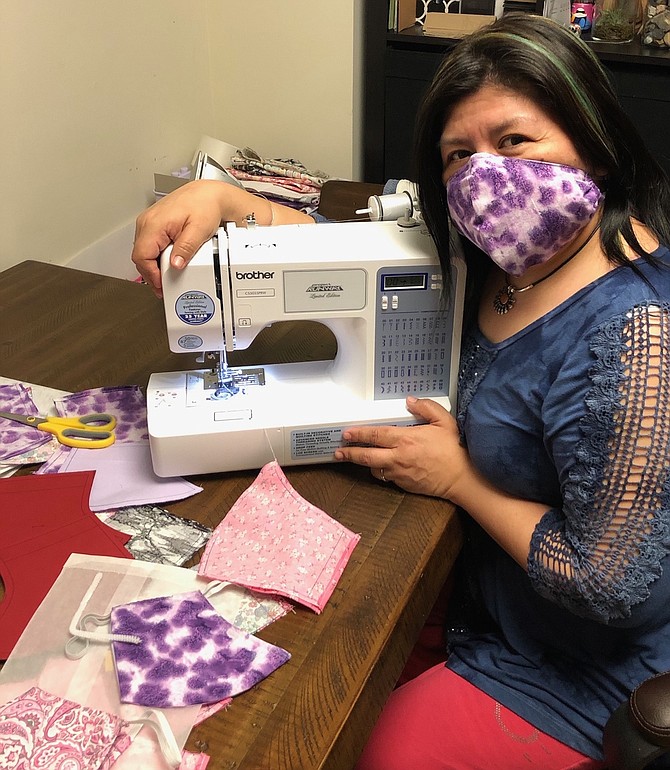 Mirabel makes large and small masks at Trade Roots on Washington Boulevard in Arlington.