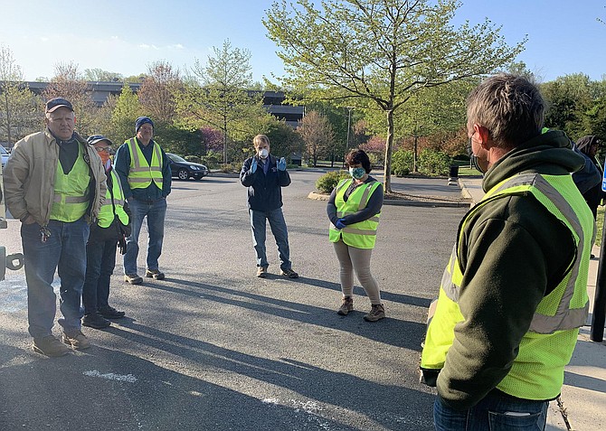 Fairfax City Mayor David Meyer speaks to the City Jobs crew at Stafford Park.