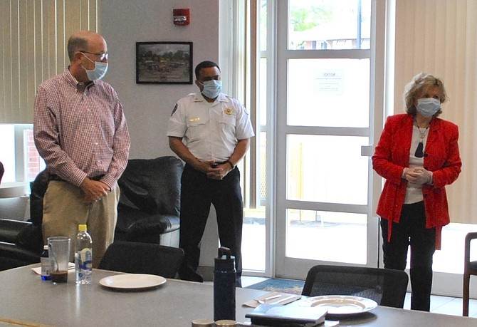 Alexandria Fire Chief Corey Smedley, center, listens as Friendship Veterans Fire Engine Association board member Marion Moon, right, kicks off the organization’s Feed the Fire/EMS meals program April 21 at AFD headquarters. Moon, along with former city councilman Frank Fannon, left, are sponsoring the initial three weekly meals for firefighters and EMS personnel.