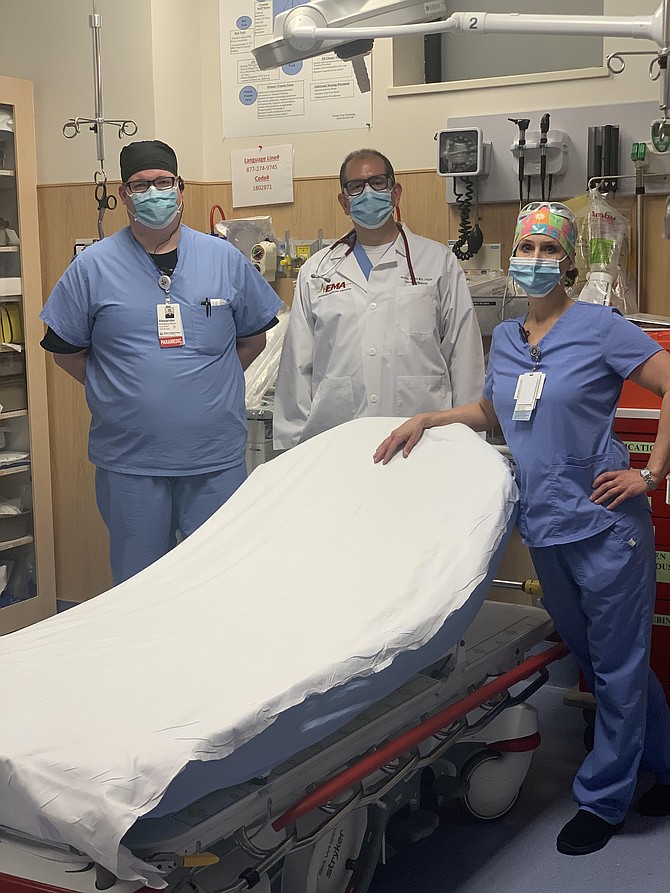 Come to the ER, it’s safe. Paramedic Alex Apple and nurse Kelly Duckworth join Chairman and Medical Director of the Department of Emergency Medicine at Reston Hospital Center HCA Virginia Health System, David Jacobs, MD, in an ER room at the hospital.