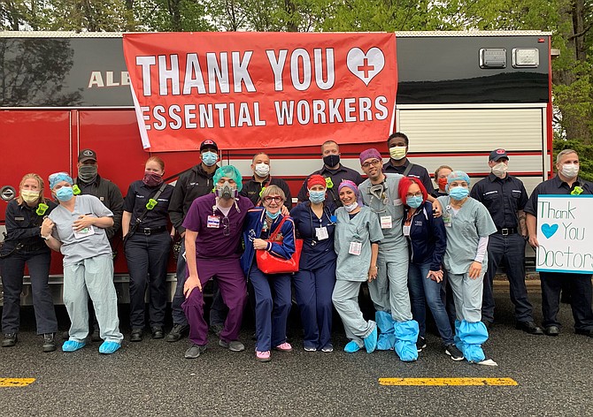 Inova Alexandria Hospital health care workers pose for a photo with members of the Alexandria Fire Department April 28 after a surprise show of gratitude from first responders for their efforts during the COVID-19 crisis.