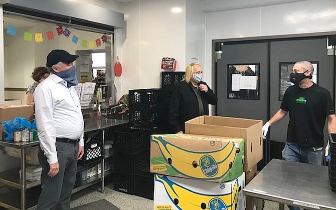 Senator Tim Kaine (left) tours AFAC warehouse with CEO and Executive Director, Charles Meng, and AFAC staff member Alcy Manente.